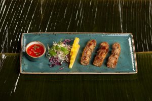 " Grilled sausages served with sweet and sour sauce"